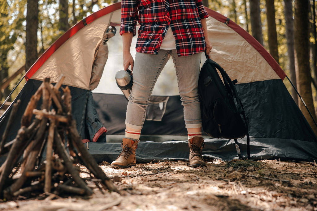 janky gear hopes to get people outside by camping, backpacking, kayaking, canoeing, biking, you name it. We consign any outdoor gear available to us by consignment. Image of man standing in front of tent, setting up a camp. 